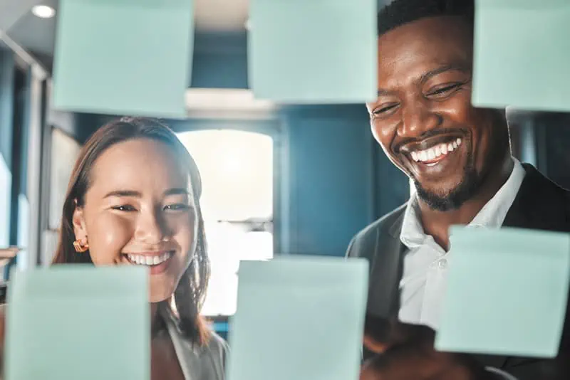 image of people using post its on a white board